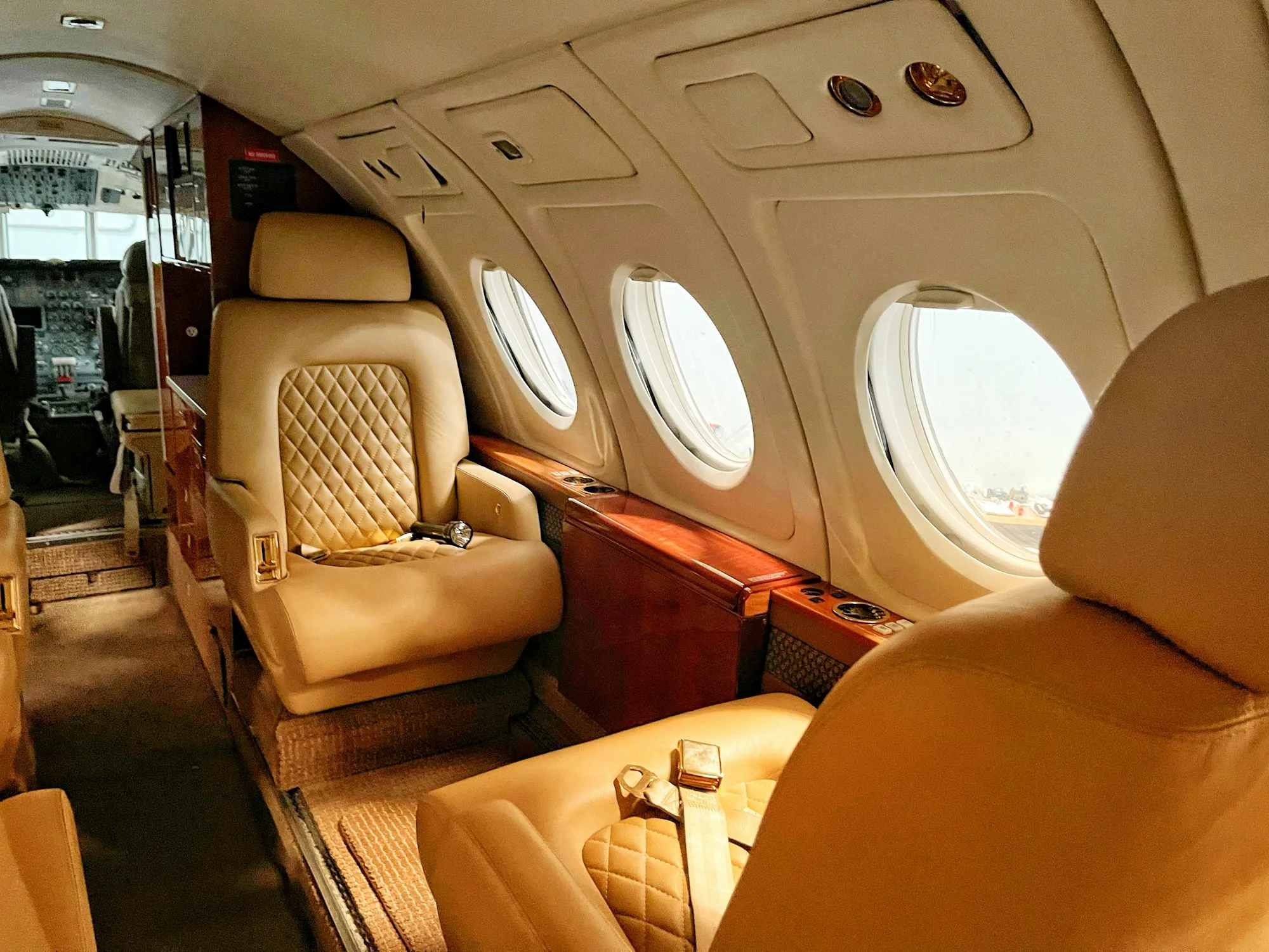 The leather-seat cabin of a private jet
