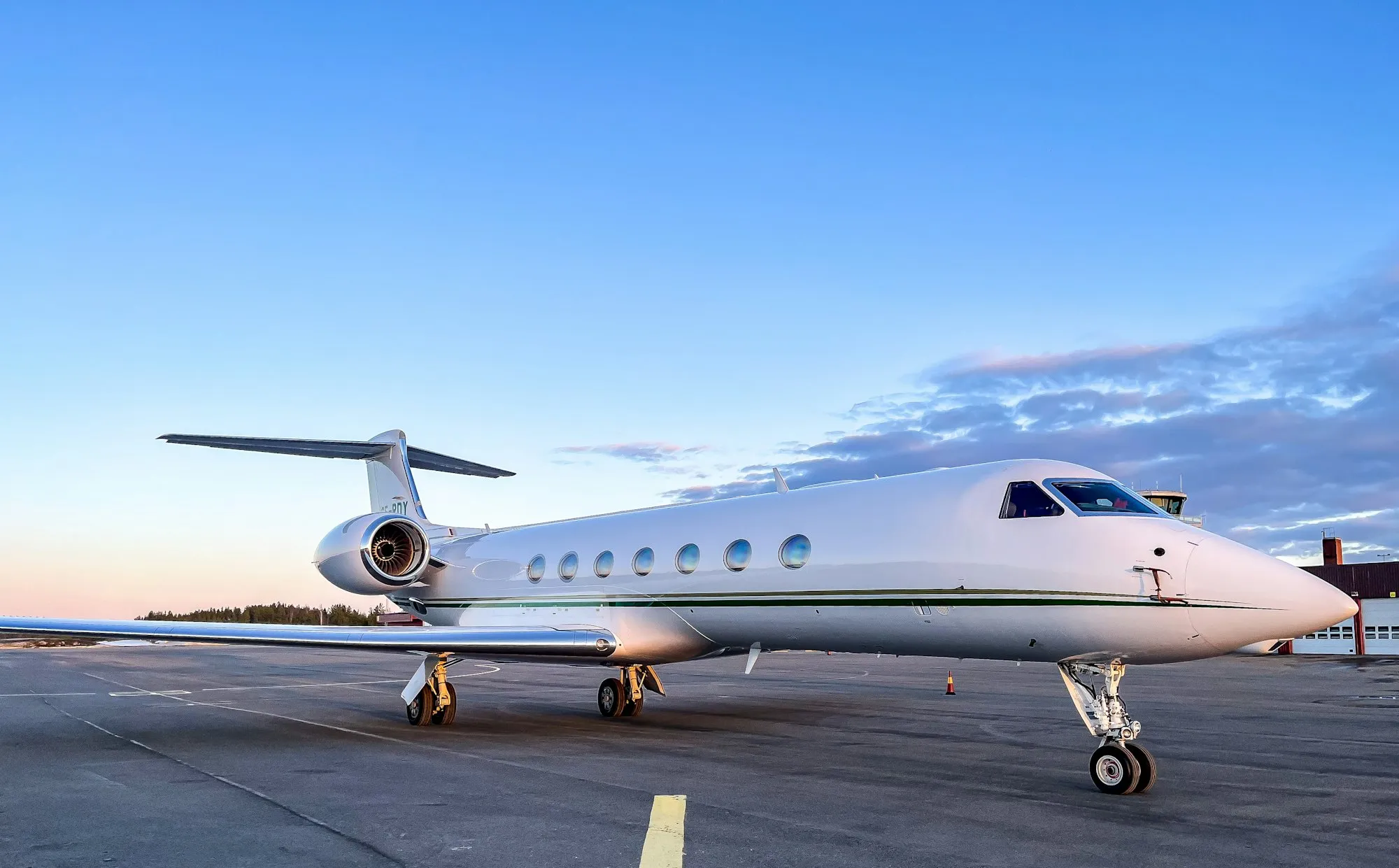 A large private jet parked on a sunny airport apron