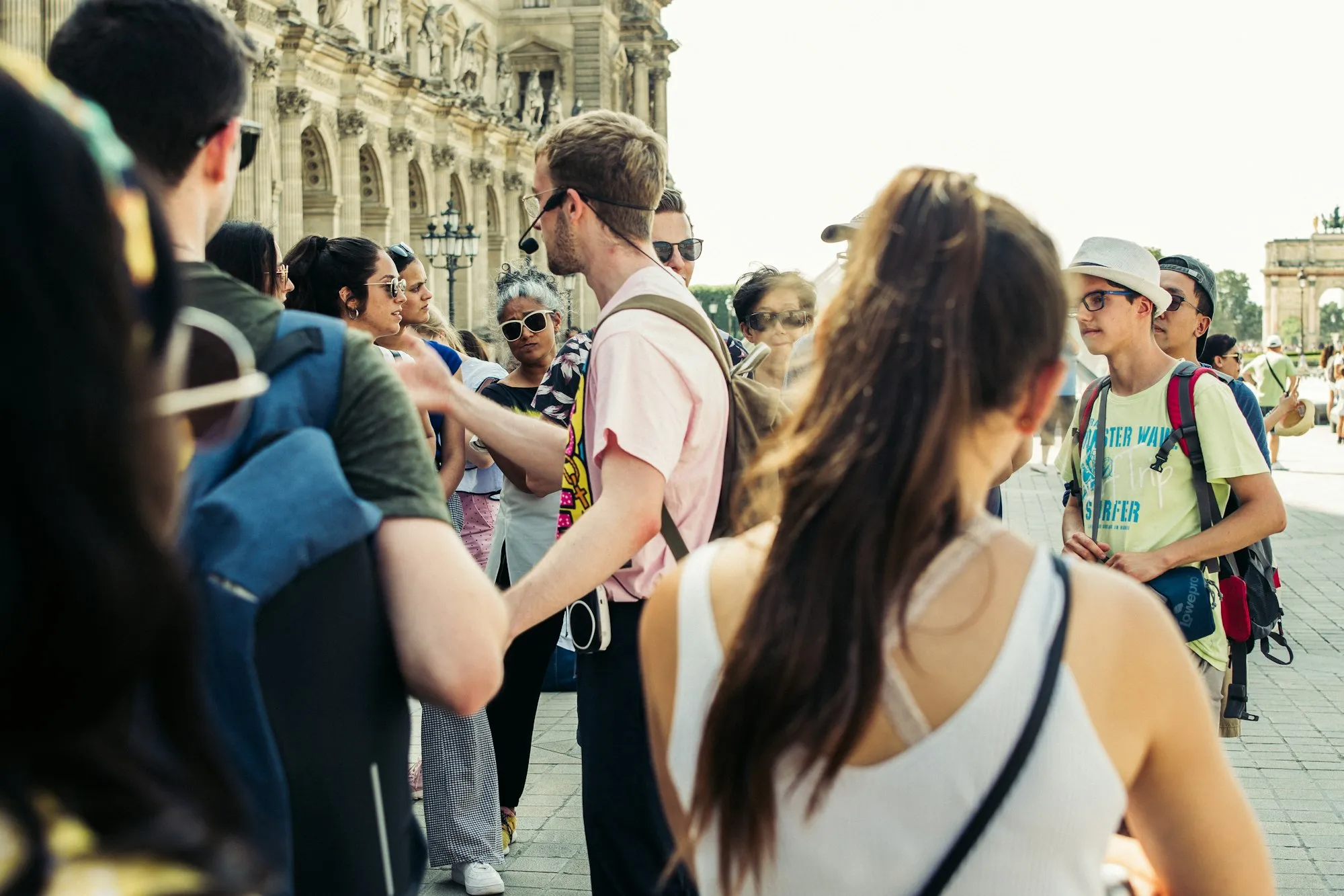 A group of travelers on a guided walking tour of a city street